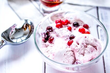 organic homemade ice cream with strawberry in glass bowl on wooden backgroundの写真素材
