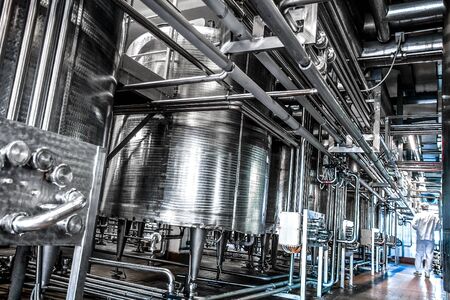 Dairy product factory inside with pipes and tanks