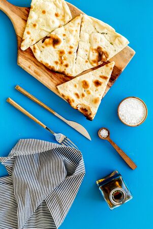 Make focaccia. Traditional italian bread with oil on blue table top-down