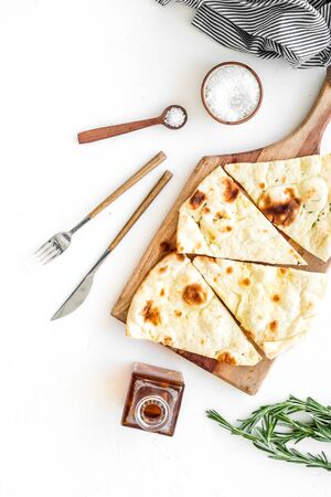 Italian focaccia with cheese and rosemary on white background top-downの写真素材