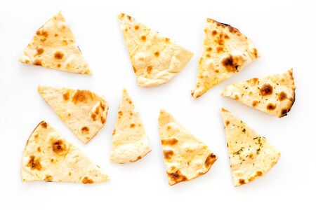 Focaccia pieces background on white table top-down