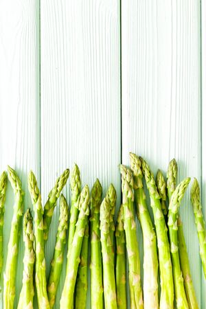 Asparagus steams frame on white wooden background top-down copy spaceの写真素材