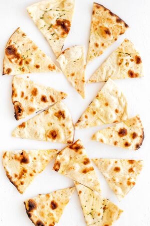 Focaccia pieces background on white table top-down