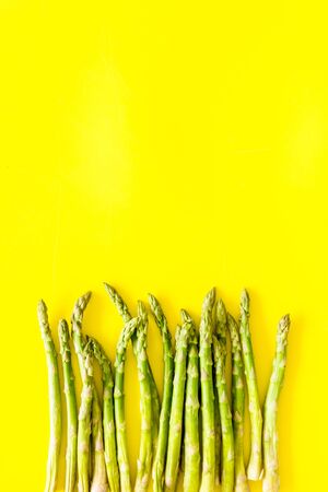 Asparagus steams frame on yellow background top-down copy spaceの写真素材
