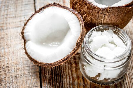 organic cosmetics with coconut on wooden background