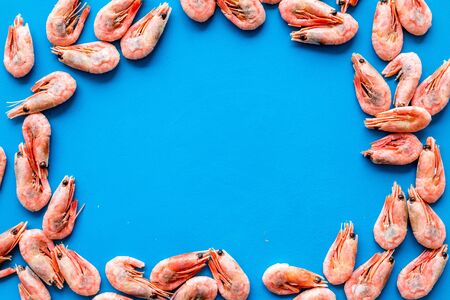 Shrimps background on blue table top view frame copy spaceの写真素材