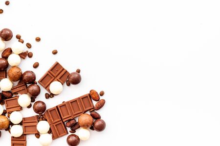 Candy background with chocolate on white table top view frame. Sweets desserts concept. Space for textの写真素材