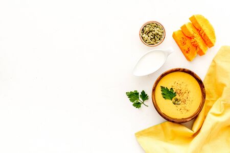 Pumpkin cream soup on white background top-down. Healthy vegetarian food.の写真素材
