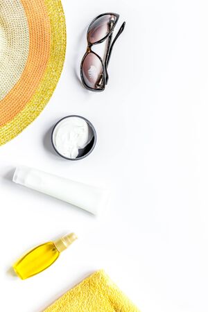 Towel, sun lotion, glasses for summer rest on white background top view space for textの写真素材