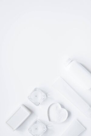 white bottles of body cream and lotion table background top view mock-upの写真素材
