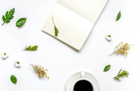 Notebook with cup of coffee on white background top view mockup