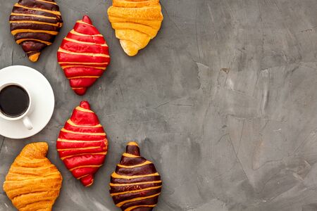 Coffee and croissants on dark stone tableの写真素材