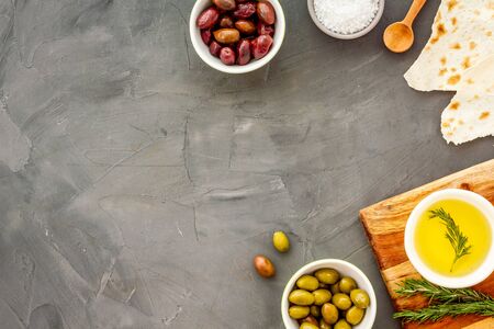 Set of olives with oil on grey