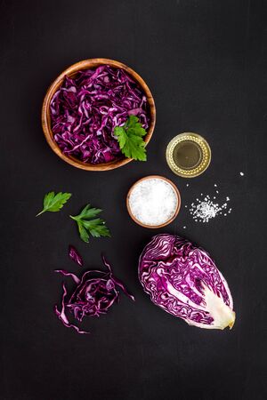 Red cabbage - cut head and sliced - on black kitchen table top viewの写真素材