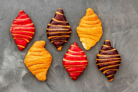 Set of croissants - chocolate, berry, classic - on gray table top view