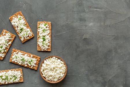 Cottage cheese toast on grey desk top view copy space