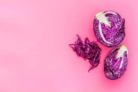 Red cabbage - cut head and sliced - on pink desk from above copy spaceの写真素材