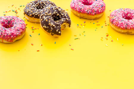 Colorful donuts close up, glazed and sprinkles bakeryの写真素材