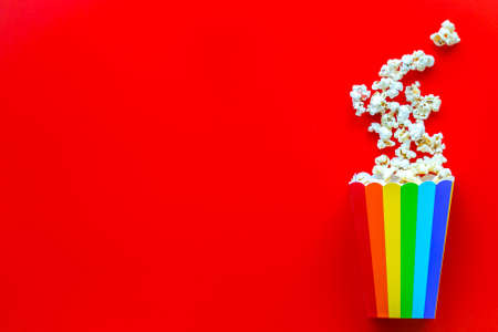 Popcorn in rainbow paper cup top-down copy space