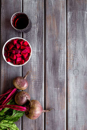 Top view of beet harvest. Green tops, slices, juice top-down space for text