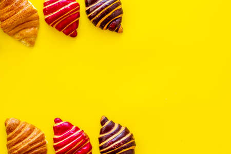 Frame of croissants - fresh bakery on yellow background. Top viewの写真素材