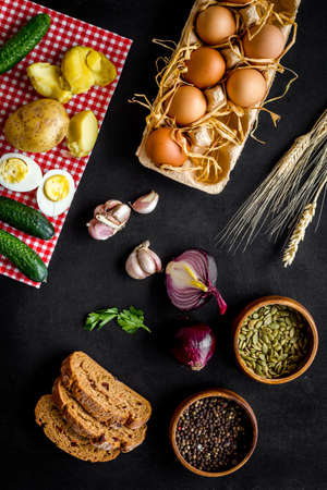 Dinner table with fresh homemade food - eggs, bread, potatoes. Overhead viewの写真素材