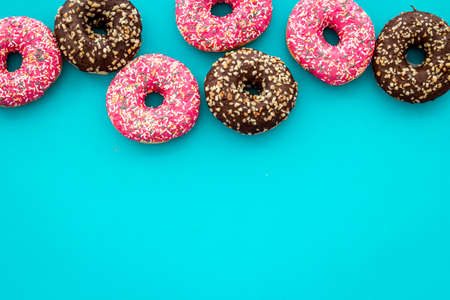 Colorful donuts pink and chocolate icing. Flat lay of bakery, above viewの写真素材