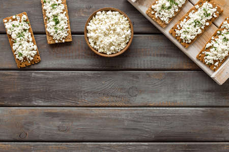 Sandwiches with cottage cheese and greenery for breakfast top view copy space