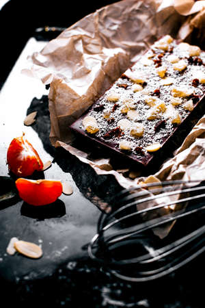 still life of chocolate bar with nuts on oven-trayの写真素材