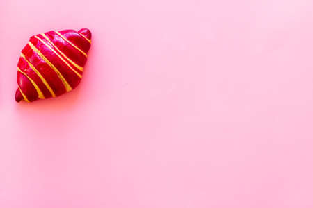 Berry croissant on pink background top view