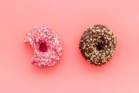 Colorful donuts pink and chocolate icing. Flat lay of bakery, above viewの写真素材