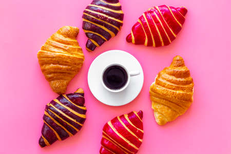 Set of coffee with croissants - chocolate, berry, classic - on pink top viewの写真素材