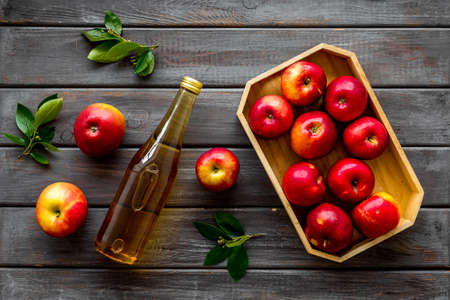 Apple cider vinegar in bottle with fruits top view