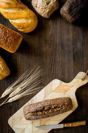 Bread, knife on cutting board. From above copy spaceの写真素材