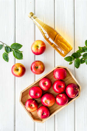 Top view of apple cider or vinegar - bottle with ripe fruits and leavesの写真素材
