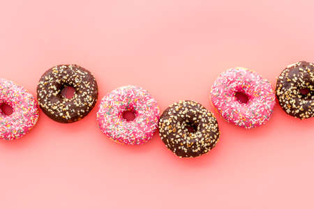 Top view of colorful glazed donut swith sprinkles, copy space