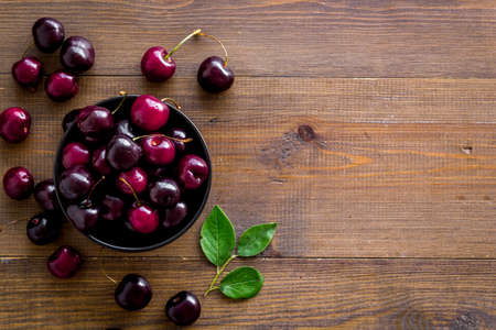 Sweet red cherries with leaves, flat lay, top view