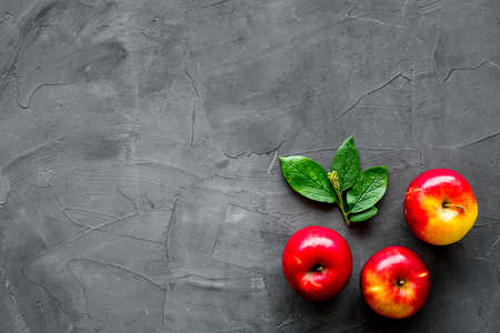 Top view of red apples with green leaves on kitchen tableの写真素材