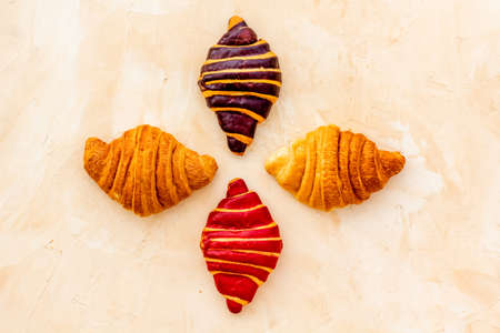 Set of croissants - chocolate, berry, classic - on stone table top viewの写真素材