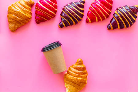 Set of coffee with croissants - chocolate, berry, classic - on pink top viewの写真素材