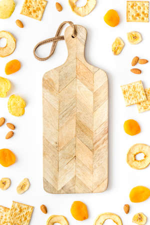 Healthy snacks overhead - nuts and dried fruits with crackersの写真素材