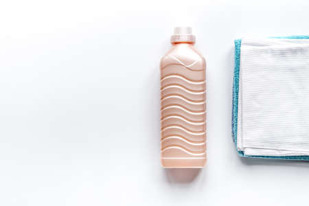 Towels set in laudry with bottles on white backgruond top view mock-up