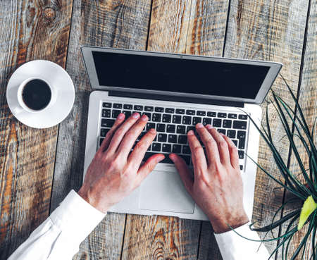 Working place for man with notebook on wooden tableの写真素材