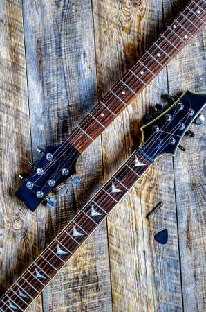 Two electric guitar bodies on wooden board background.の写真素材