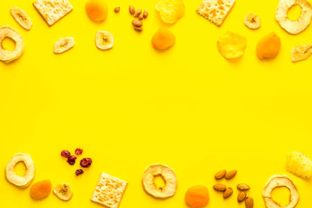 Snacks mix frame top view. Nuts and dried fruits with crackers, copy spaceの写真素材