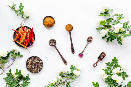 Hot spices set with herbs and flowers, top view