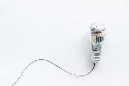 Save money and energy power concept - dollar in light bulbの写真素材