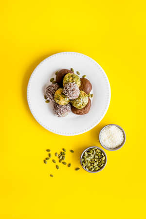 Raw coconut and chocolate energy balls, top viewの写真素材