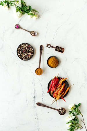 Cooking utensils and hot spices in metal bowls and spoons. Top viewの写真素材