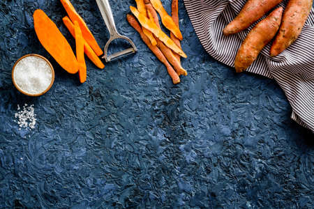 Overhead view of sweet potato sliced on kitchen board. Top viewの写真素材